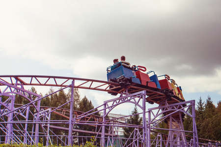 Roller coaster track blue sky at amusement park. people ride the dangerous ridesの写真素材