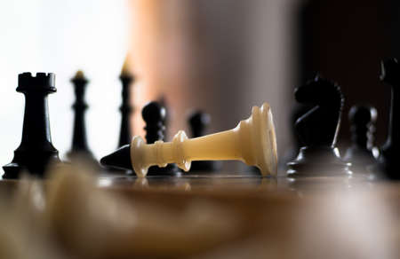 The chess pieces are placed on the chessboard. Defeated white king. The player admitted defeatの写真素材