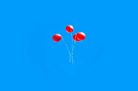 the red balloons in the blue skyの写真素材