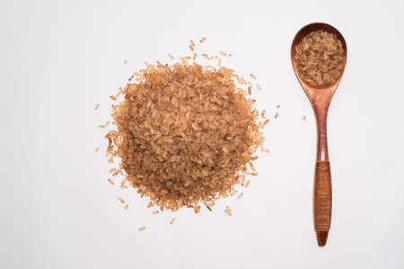 Red rice with a wooden spoon close up. the portion of rice in a spoon slideの写真素材