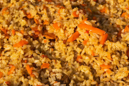 Traditional Middle Eastern or Indian dish of rice pilaf cooked with spices. background of cooked rice yellow. texture of the pilau, pilawの写真素材