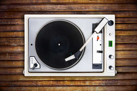The old Soviet vinyl player isolated on wooden background. turntableの写真素材