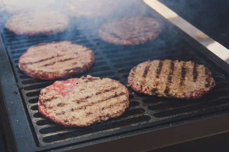 Cutlets from minced meat roasted on the grill. Meat hamburger Patty closeup. Ingredients for Burger. cooking barbecue outsideの写真素材