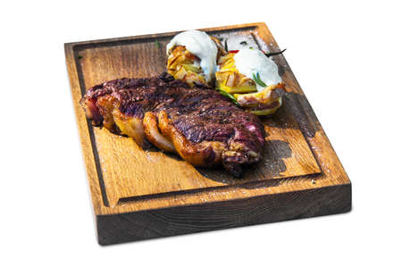 Grilled beef steak on wooden board on an isolated white backgroundの写真素材