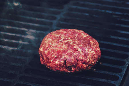 Close-up of beef cutlet, for burger, fried in grill, cutlet cuddle culinary, cooking processの写真素材