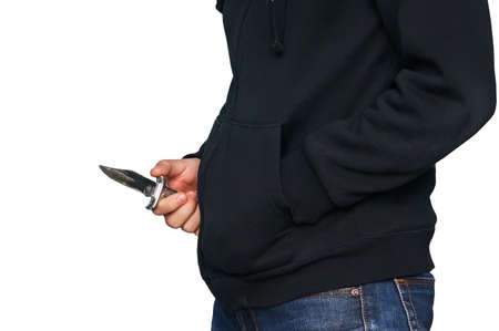 The male criminal in action of attacking with knife. Isolated on white background. The concept of crime for presentation slide. a robber with a knife in the hoodie.の写真素材