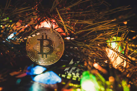 bitcoin and new year. Crypto currency bitcoin on a Christmas background. problems and business growth. New Year's warm tinting.の写真素材