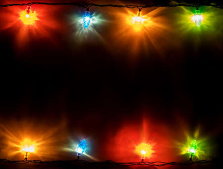 christmas garland lights on blue wooden background with copy space for your text. Top view. View...
