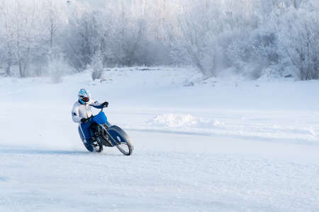 motorcycle on studded tires. Extreme bike race in winter. motorcycle on the ice of the frozen Lake Baikal. Racer on ice. Motorcycle with studded tires driving on the frozen lake. Winter extreme sportsの写真素材