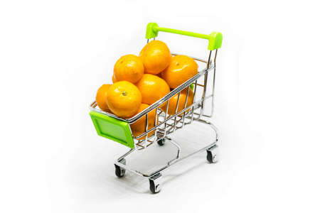 Metal shopping basket on wheels with green handle with mandarin inside isolated on white background, consumer basket, food cart, front and side viewの写真素材