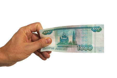 man hand holding money, sharing one thousand ruble banknotes. Isolated on white background. Hand...