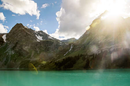 Dramatic landscape with mountains at coastline and tranquil water with sky day with dramatic sky in...