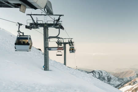 gray cable car lift at ski resort. vintage winter picture. cable car, cableway, ropeway, cable way, cable railway, funicular railway, aerial cableway, rope road. Medeo Kazakhstan. ski resort Shymbulakの写真素材