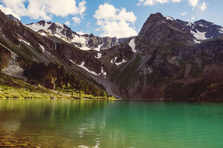 Lake in the mountains. Beautiful mountain landscape with one small mountain and a lakeの写真素材