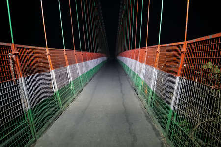 Laxman Jhula suspension bridge on river Ganga. Suspension bridge painted in the color of the Indian flag at night. Rishikesh Indiaの写真素材