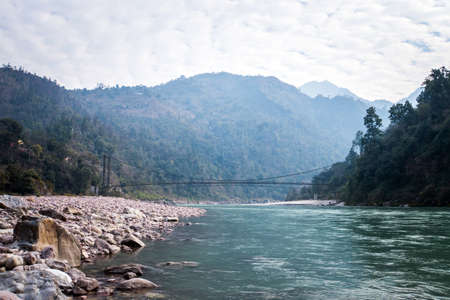bridge in the vicinity of Rishikesh India. Suspension bridge over river. Long rope bridge cross the stream in the villageの写真素材