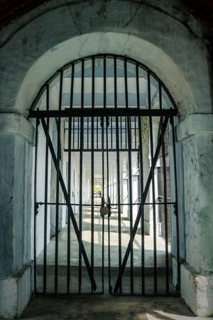 ancient dungeon. metal grill. Closed prison door. The concept of a prison, Gulag and political repressionsの写真素材
