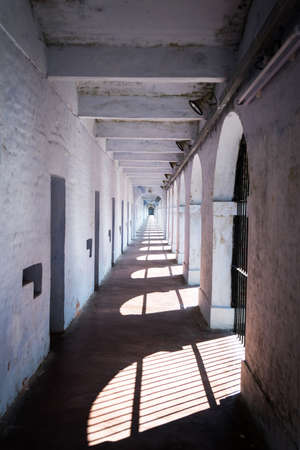 A long corridor in the old prison building with solitary confinement on its side.の写真素材
