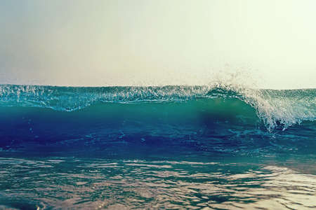 Looking at a barreling wave break in an empty line up.の写真素材