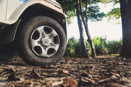 truck on a bad road. The wheel of the SUV in the mud in the foreground.の写真素材