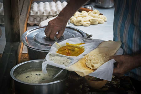 Appam Palappam , a popular traditional Kerala breakfast bread with masala egg curry gravy on a houseboat, Alappuzha Kuttanad, India. South Indian food served in bright colorful background.の写真素材