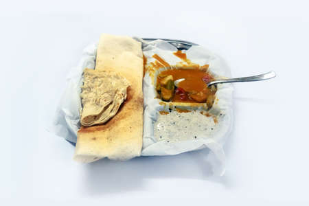 A Customer with Butter Masala Dosa at the popular Pragathi Tiffin Center in Hyderabad,India. Dosa or dosai. traditional Indian food in a plate with different sauces. isolated on white backgroundの写真素材
