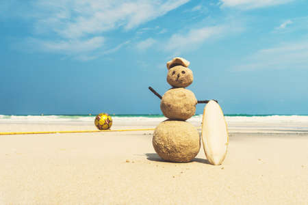 tourist traveler blinded by the sand on beach amid the beautiful sea and blue cloudy sky. concept of tourism, travel to warm countries in winter. entertainment during holiday. traveler, hiker, camperの写真素材