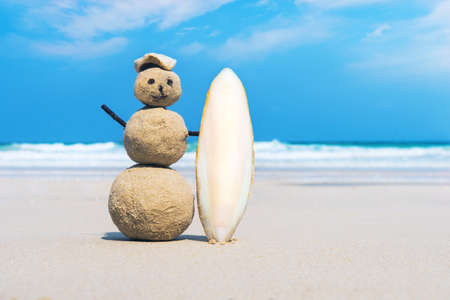 joyful Sandman of white sand on the clean beach of an exotic island on the background of blue sea and cloudy sky.の写真素材