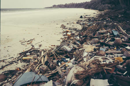 Fishermen live along the coast, leaving plenty of waste on the coast and throwing it into the sea. Make the water rot and dead. big mountain of garbageの写真素材