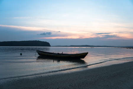 Fishing boat in Songkhla Lake At sunset. Silhouettes on sea water background.の写真素材