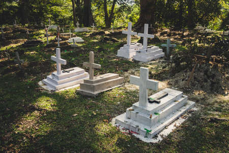 Old grave on traditional European cemetery in Slovakia. Aged cross tomb stone on grave yard in spring. cemetery in the forestの写真素材