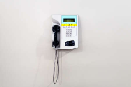 white public telephone over white background. Pay phone with credit or debit card.の写真素材