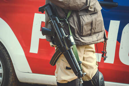 Special forces. machine gun on a COP's shoulder. commando stands with armsの写真素材