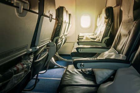 Airplane seat and window inside an aircraft. Inside the cabin of a Boeing. Seats in economy class.