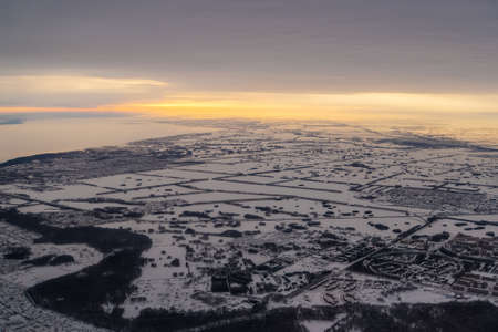 Aerial view to the city in the Kazakh steppe. during the evening sunset. Winterの写真素材