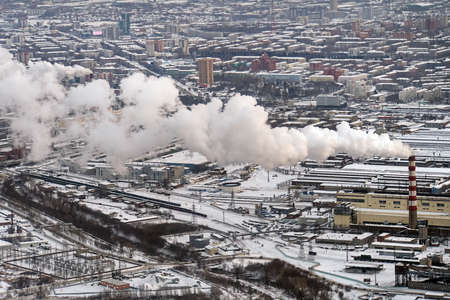 smog in a european city, aerial view, poor environment in the modern industrial city. white thick smoke from tall factory pipes. top view of the heating plant.の写真素材