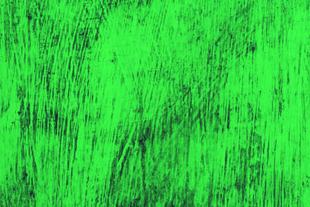 green wooden background. A wooden wall is covered with bright rich old paintの写真素材