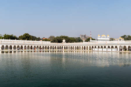 Sacred pond in front of the temple Gurudwara Bangla Sahib, Golden Temple in Delhiの写真素材