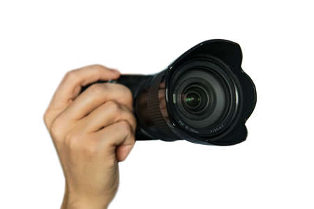 Photo camera in hand isolated on white background. Small size mirrorless camera with telephoto lens on white background. isolateの写真素材