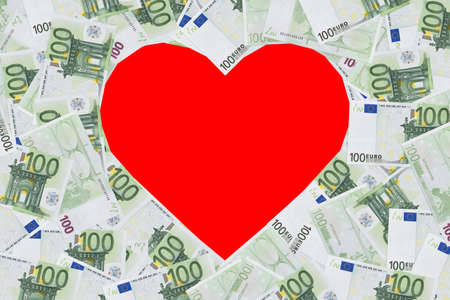 Heart shape sign with 100 euro banknotes. Valentine concept background. happy Valentine's day the inscription on blank pink background heart. cash gift for a loved one. holiday 14 Februaryの写真素材