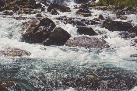 River coast with stones. turbulent water flow over rocks in a mountain river