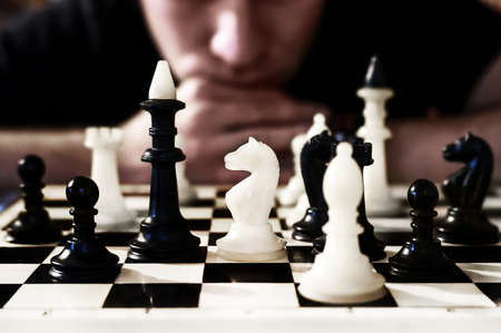 man thinking how to play chess. concept strategy for win. Want to see the chess pieces on the Board.の写真素材