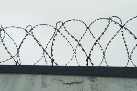 The tangle barb with gray sky. the fence at the prison.の写真素材