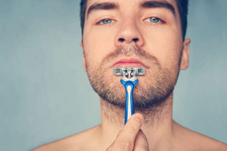 Beauty and healthcare concept. Man with bristle on blue background.の写真素材