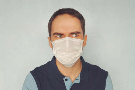 Man in medical mask blue background.の写真素材
