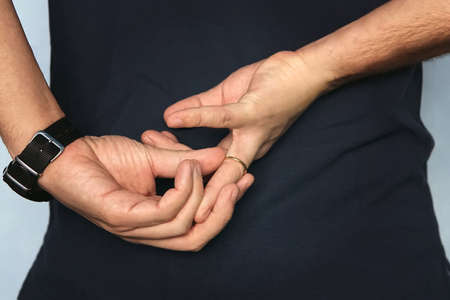 Man is taking off the wedding ring. concept of treason. Husband cheats on wife. cheating wifeの写真素材