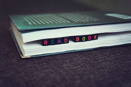 Books are close-up. A stack of books with the inscription on the cubes, Hobbies reading booksの写真素材