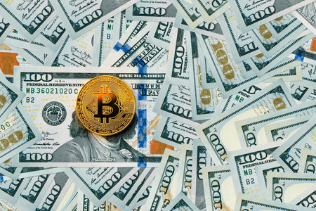 Golden metal bitcoin on dollarのeditorial素材
