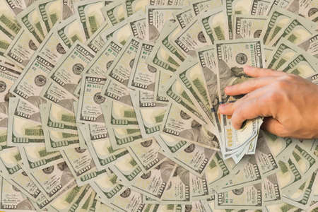 a million dollars in the hands of men. big win in the casino. man is holding money. Background of...