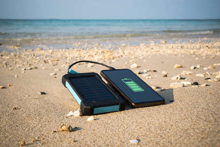frameless Smartphone close up on a sandy beach with copy space, the concept of restoring strength and energy. watertight, imperviousの写真素材